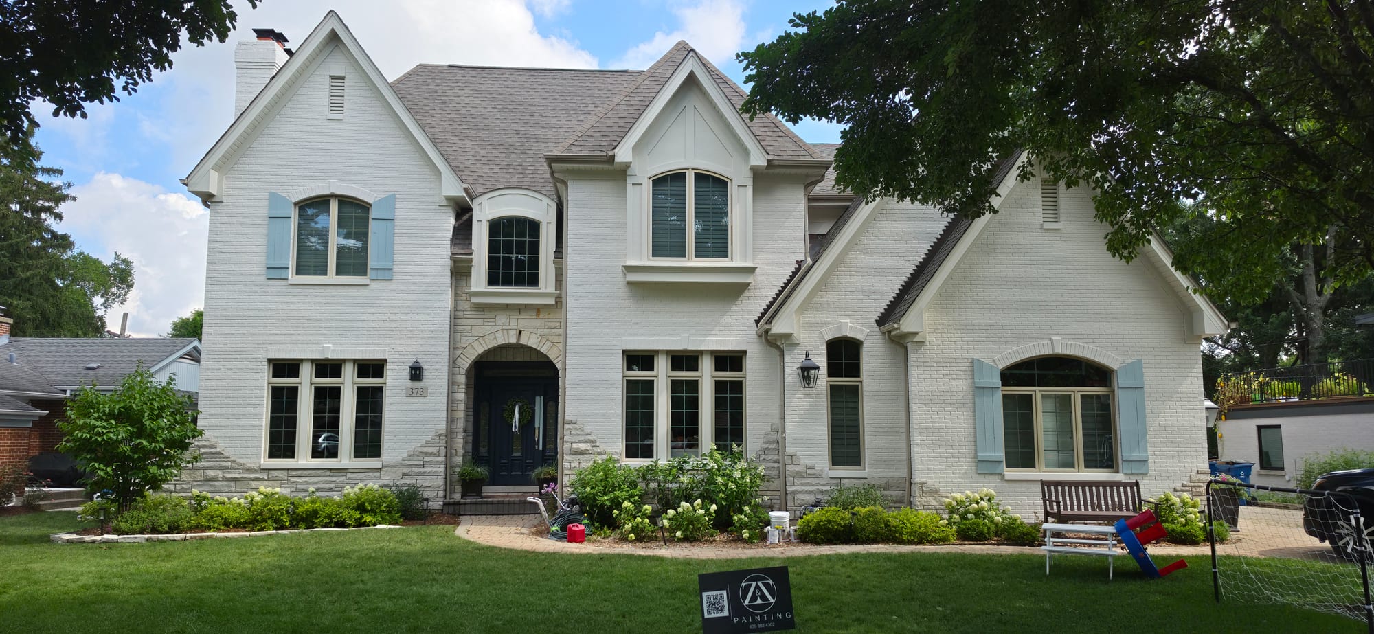Same brick exterior after Masonry Flat, fully finished white
