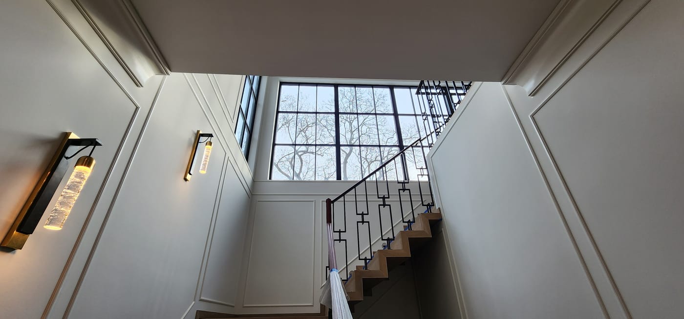 Stairwell White Walls Wainscoting Iron Railing - Interior Painting by Z&Z Painting
