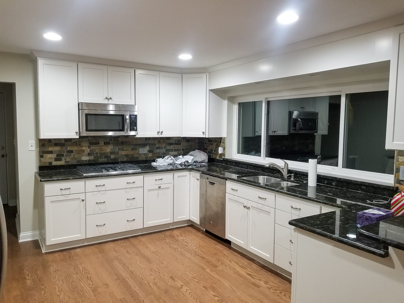 White Cabinets Black Countertops Sleek Kitchen - Cabinet Painting by Z&Z Painting